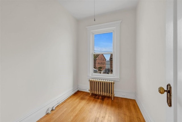 spare room with light hardwood / wood-style flooring and radiator