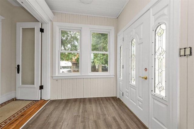 entryway with crown molding and hardwood / wood-style floors