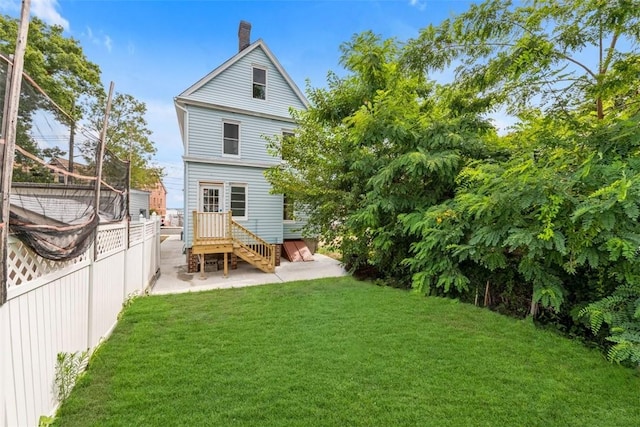 rear view of house with a lawn