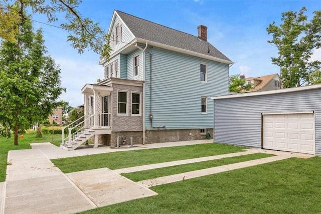 view of side of property featuring a garage and a lawn