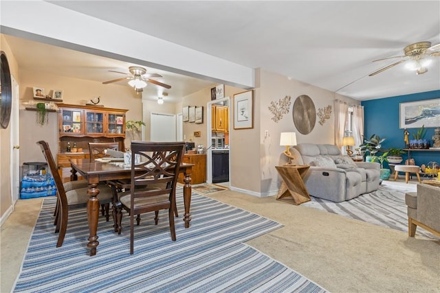 carpeted dining space featuring ceiling fan