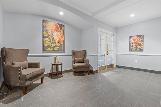 sitting room with french doors, tile patterned floors, and beam ceiling