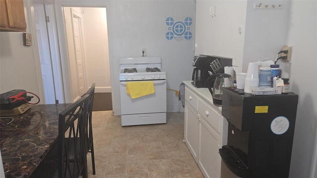 kitchen featuring white cabinetry and white appliances