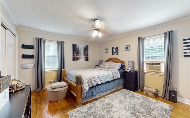 59 Ludingtonville Rd, Holmes, NY 12531 - bedroom featuring cooling unit, wood finished floors, crown molding, a closet, and a ceiling fan
