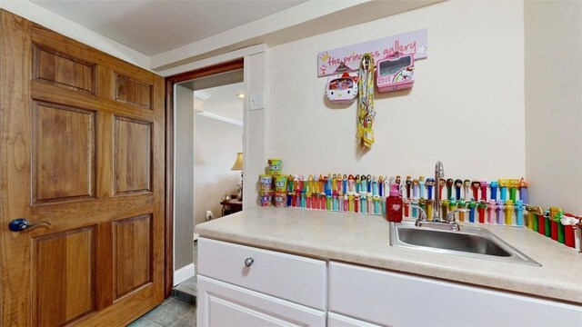 59 Ludingtonville Rd, Holmes, NY 12531 - kitchen with light countertops, a sink, light tile patterned floors, and brown cabinetry
