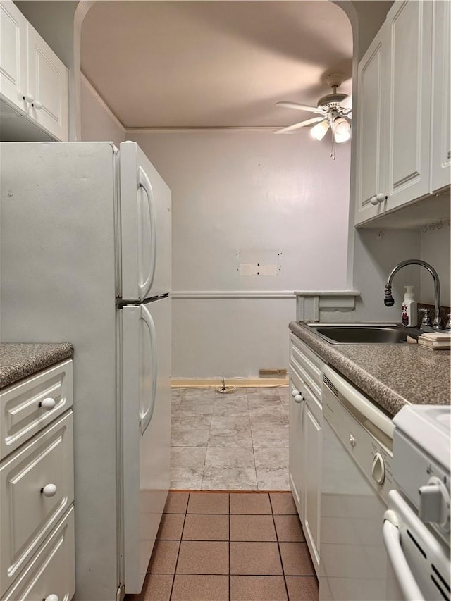 kitchen featuring white cabinetry, sink, ceiling fan, white appliances, and light tile patterned floors