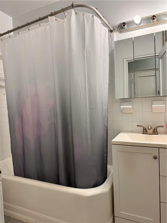 bathroom featuring vanity, tasteful backsplash, tile walls, and shower / bathtub combination with curtain