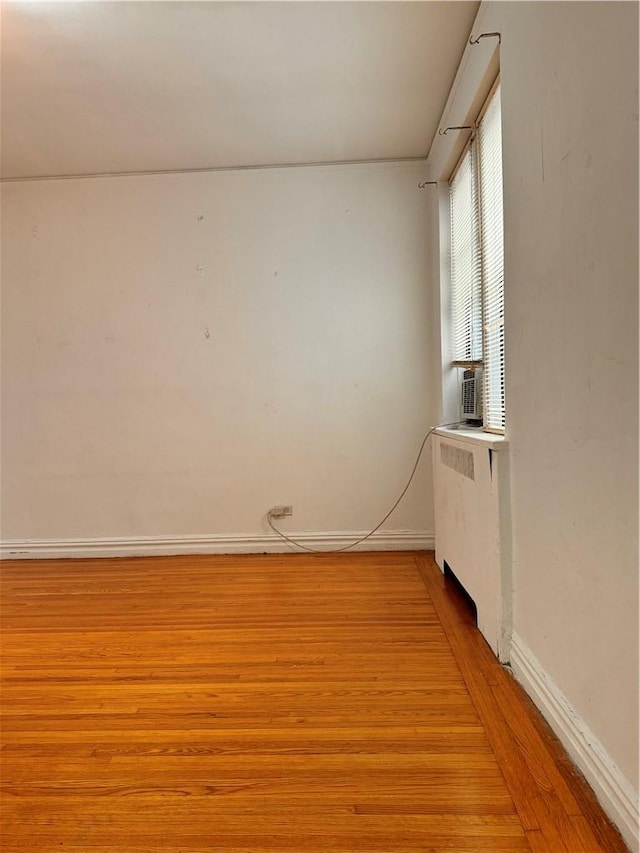 empty room with radiator and light hardwood / wood-style floors