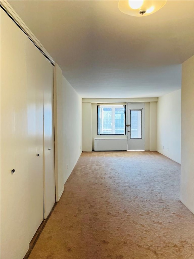 empty room featuring light colored carpet