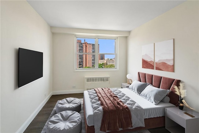 bedroom with dark wood-type flooring and radiator