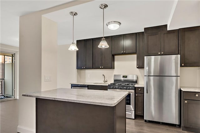 kitchen with dark brown cabinetry, stainless steel appliances, dark hardwood / wood-style floors, and sink