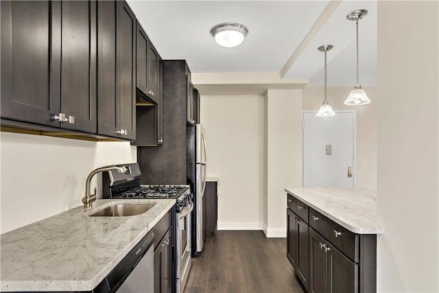 kitchen featuring hanging light fixtures, light stone countertops, dark hardwood / wood-style flooring, and stainless steel appliances