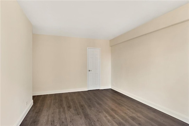 unfurnished room with dark hardwood / wood-style floors