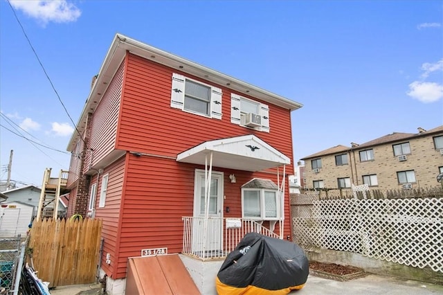 rear view of property with cooling unit