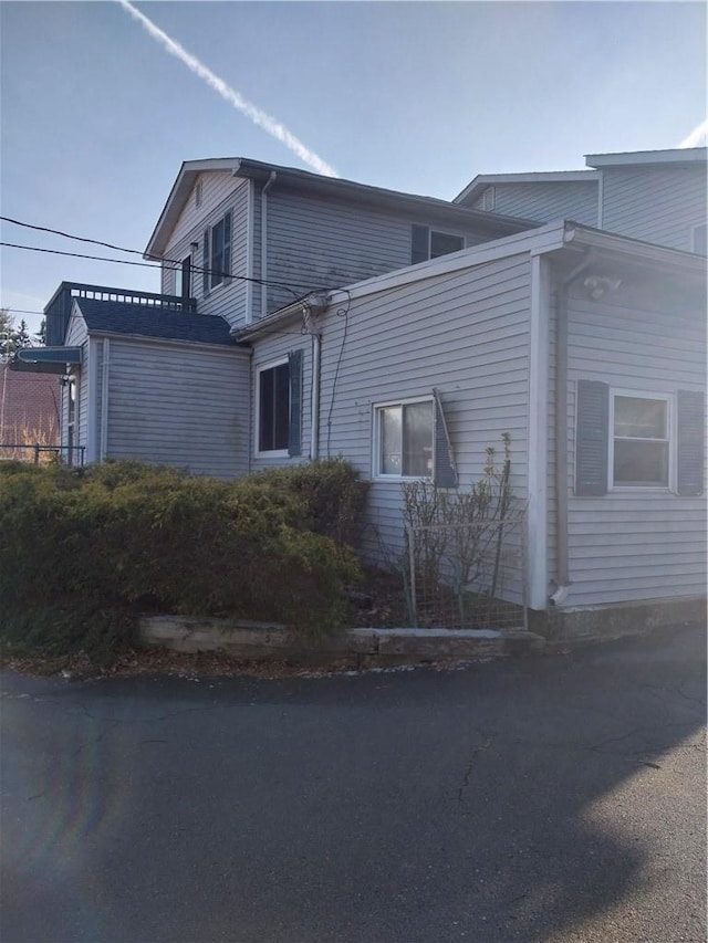 view of side of property with a balcony