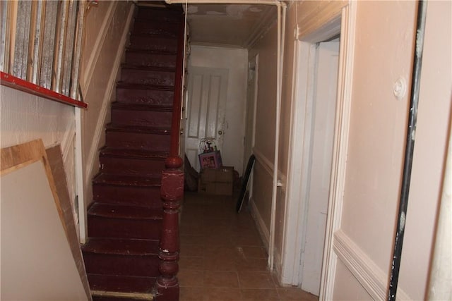 staircase featuring tile patterned floors