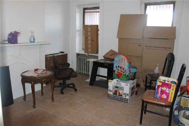 interior space featuring light tile patterned flooring and radiator