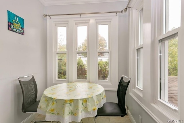 dining room featuring plenty of natural light and ornamental molding