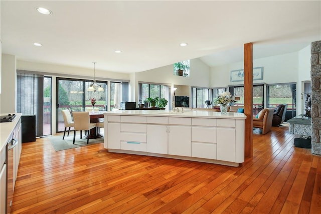 kitchen featuring hanging light fixtures, white cabinets, and light hardwood / wood-style floors