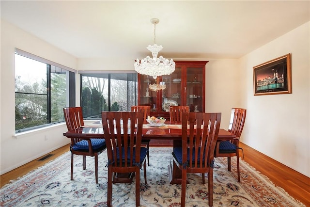 dining area featuring a chandelier and hardwood / wood-style floors