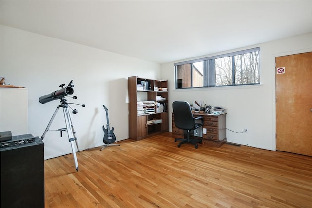 home office with wood-type flooring