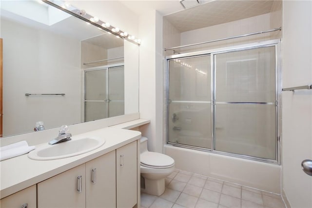 full bathroom featuring vanity, bath / shower combo with glass door, and toilet