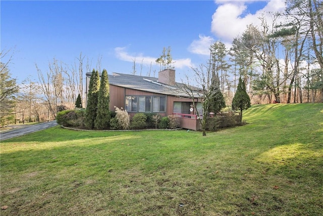 view of property exterior with a lawn