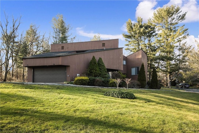 view of side of property featuring a yard and a garage