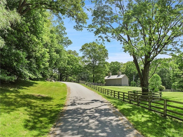 surrounding community with a rural view and a yard