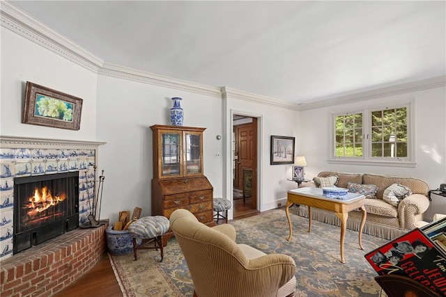 living room with a fireplace, wood-type flooring, and ornamental molding