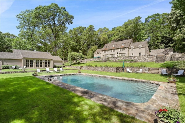 view of swimming pool with a yard and a patio