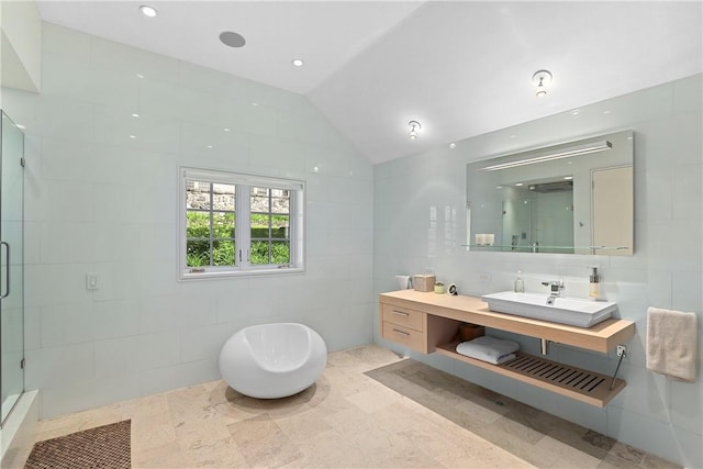 bathroom featuring separate shower and tub, tile walls, vanity, and vaulted ceiling