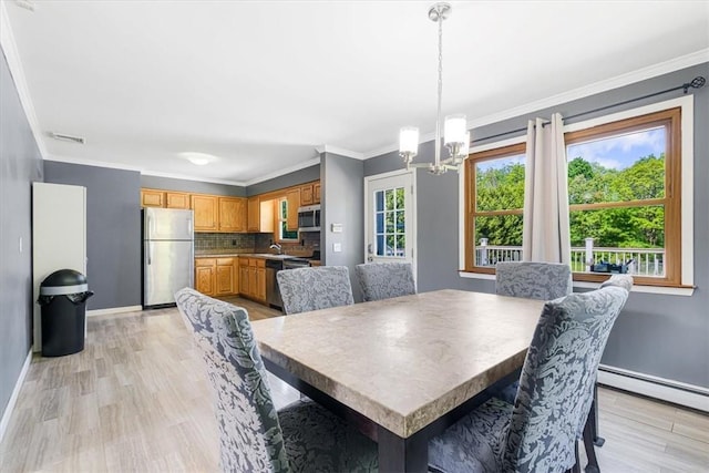 7 Joan Ln, Wappingers Falls, NY 12590 - dining room featuring a chandelier, ornamental molding, baseboards, light wood-style flooring, and a baseboard radiator