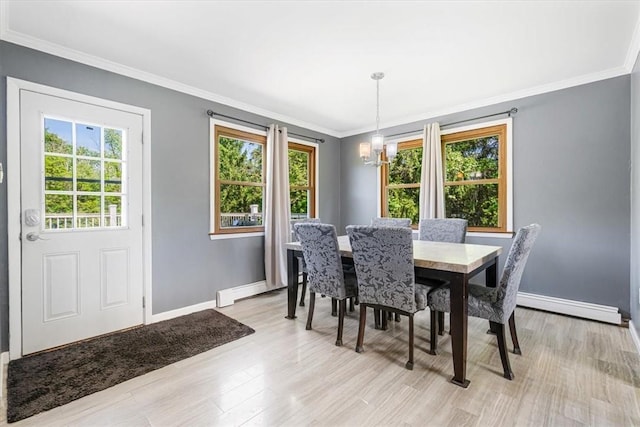 7 Joan Ln, Wappingers Falls, NY 12590 - dining space featuring healthy amount of natural light, baseboards, a chandelier, baseboard heating, and ornamental molding