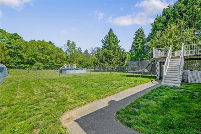 7 Joan Ln, Wappingers Falls, NY 12590 - view of yard featuring stairway, a trampoline, and a deck