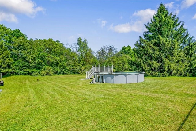 7 Joan Ln, Wappingers Falls, NY 12590 - view of green lawn with an outdoor pool and a view of trees