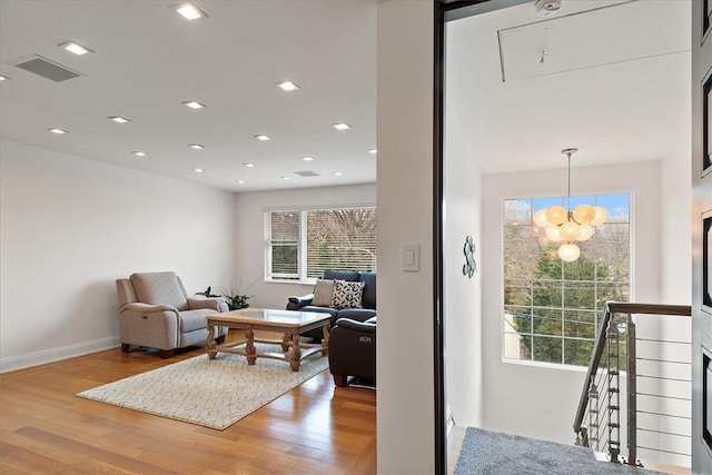 living room with a notable chandelier and wood-type flooring