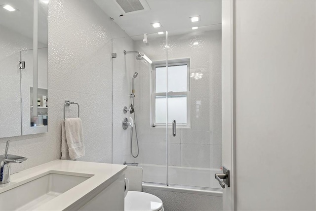 full bathroom featuring vanity, toilet, and enclosed tub / shower combo