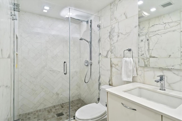 bathroom featuring vanity, toilet, and walk in shower