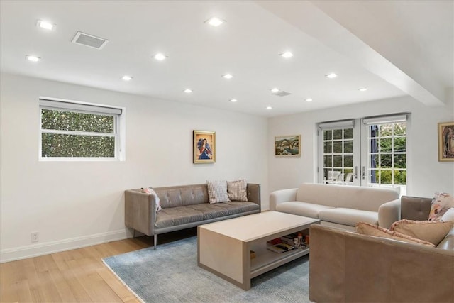 living room with french doors and light hardwood / wood-style floors