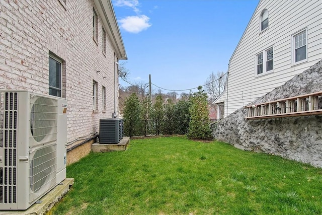 view of yard with ac unit and central AC