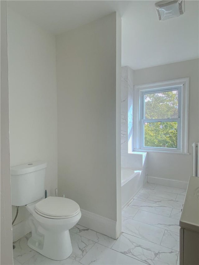 bathroom with toilet and a bathtub