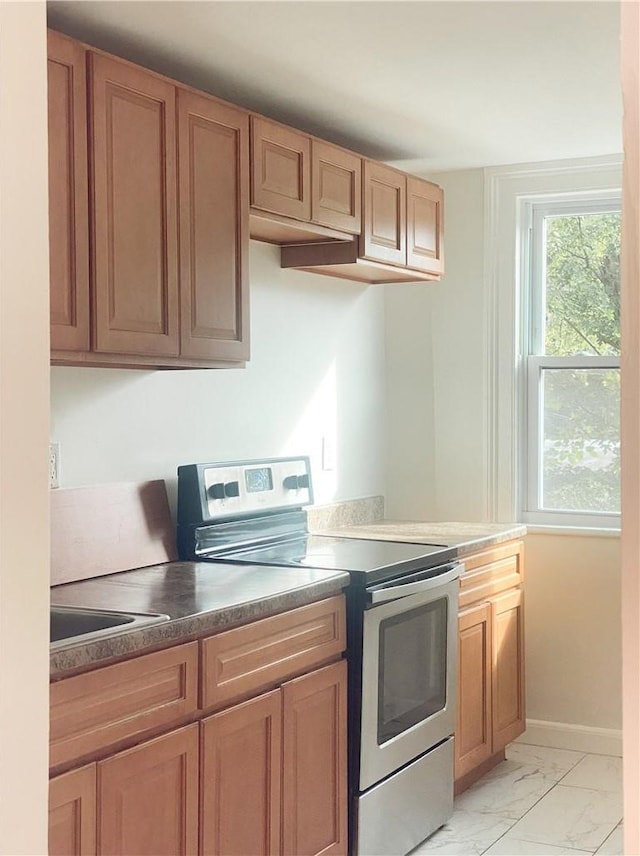 kitchen featuring electric stove and sink