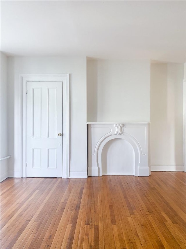 unfurnished living room featuring hardwood / wood-style floors