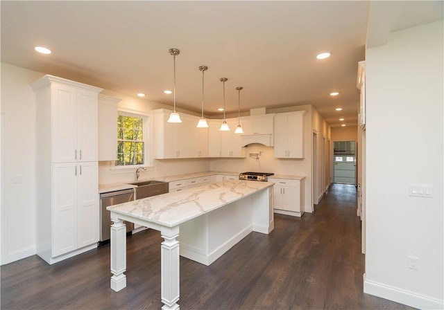 kitchen featuring white cabinets, a kitchen island, dark hardwood / wood-style floors, and appliances with stainless steel finishes