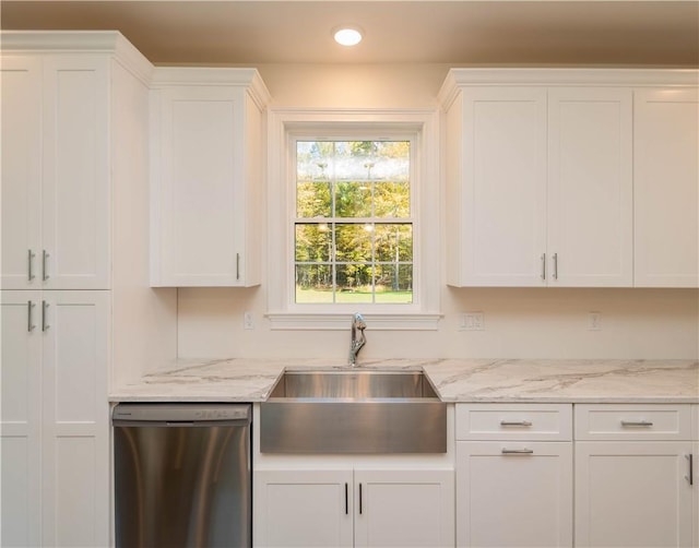 kitchen with white cabinetry, stainless steel dishwasher, and sink