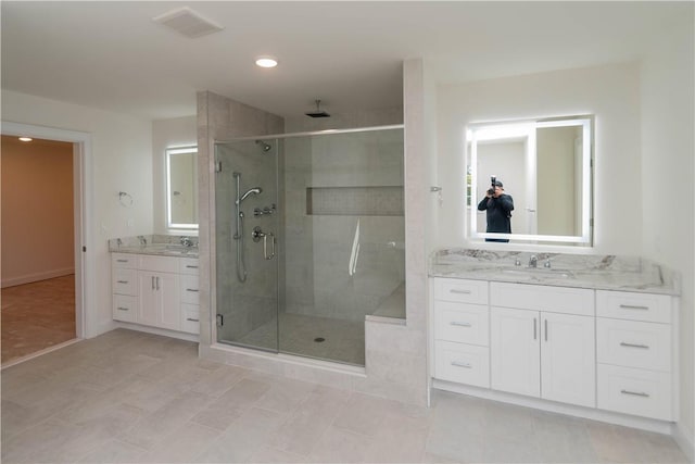 bathroom with tile patterned flooring, vanity, and an enclosed shower