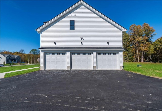 view of property exterior with a lawn and a garage