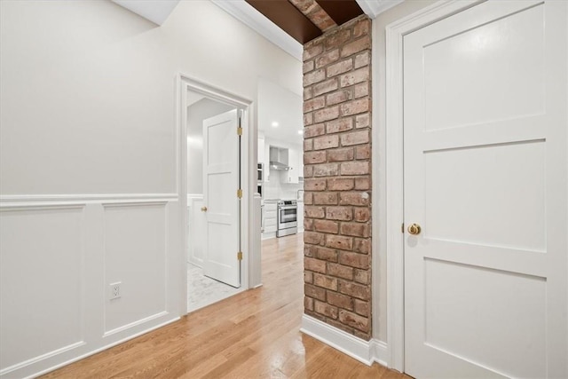 corridor with light hardwood / wood-style flooring