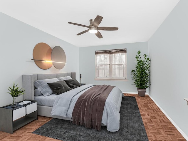 bedroom featuring ceiling fan and parquet flooring